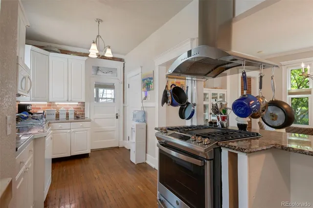 a kitchen with stove and cabinets
