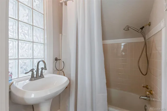 a bathroom with a sink a mirror and a shower