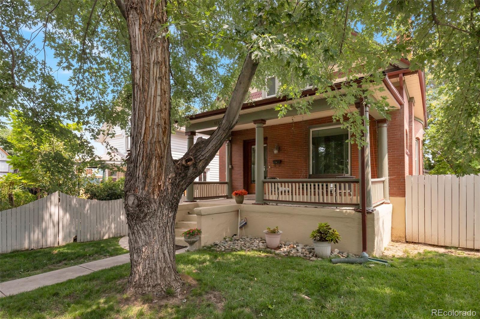 3732 Alcott Street Denver, CO 80211 - Photo 19 of 19 a view of a house with a tree in a yard