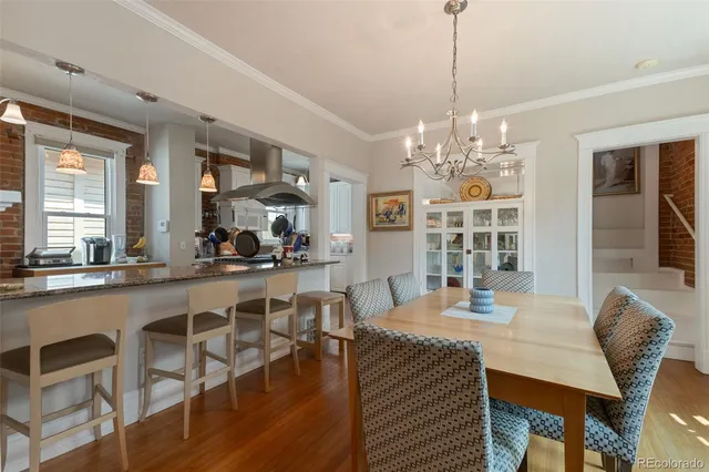 a view of a dining room with furniture wooden floor and chandelier