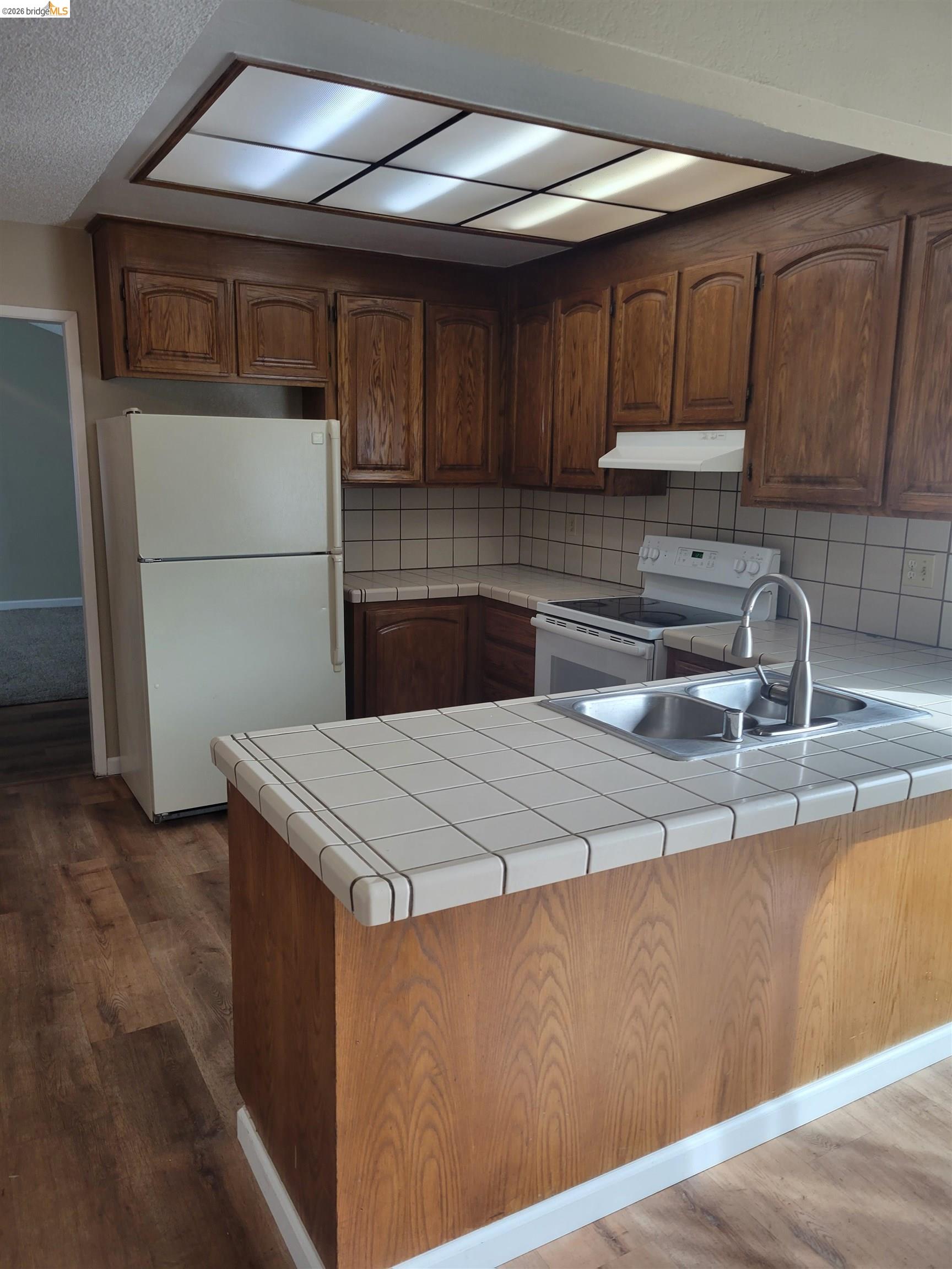 906 Coral Drive Rodeo, CA 94572 - Photo 4 of 21 a kitchen with a sink and cabinets
