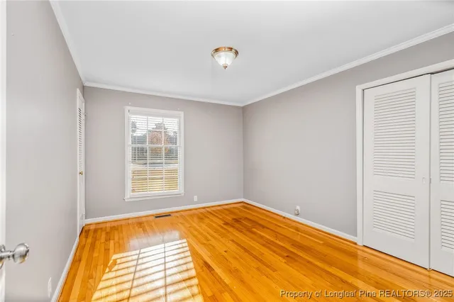 a view of a bedroom with a bed and a window