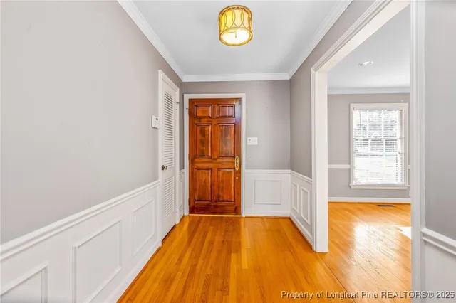 a view of empty room with window and wooden floor