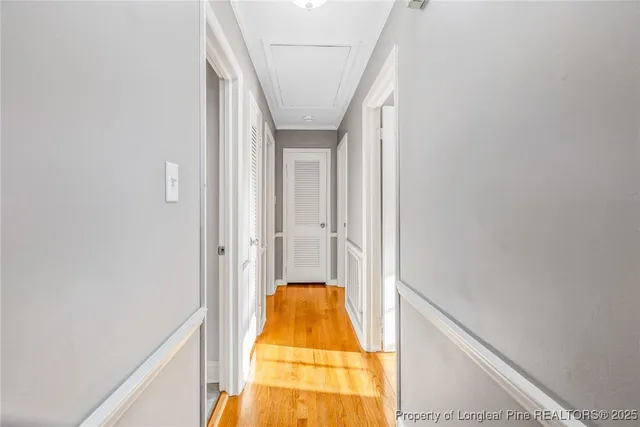 a view of entryway and hall with wooden floor