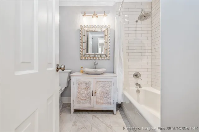 a bathroom with a bathtub sink and mirror