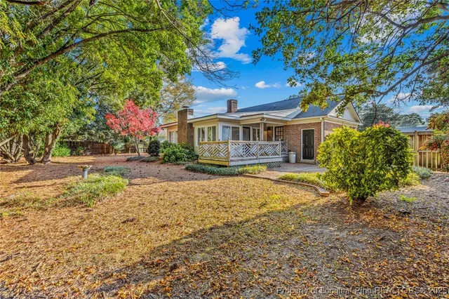 a front view of a house with yard and green space