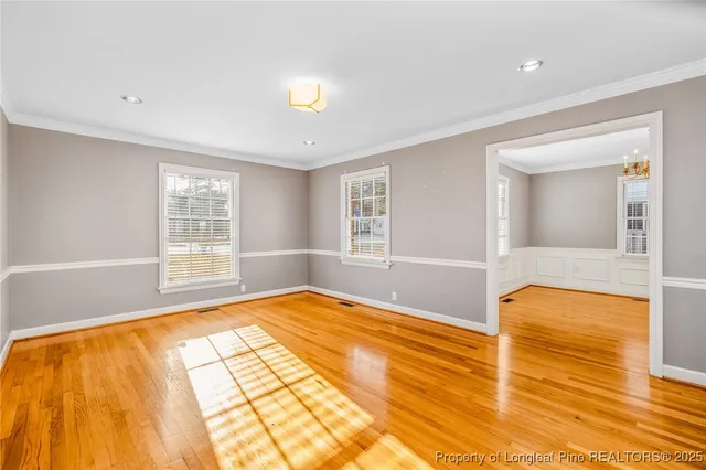 a view of an empty room with window and a bathroom
