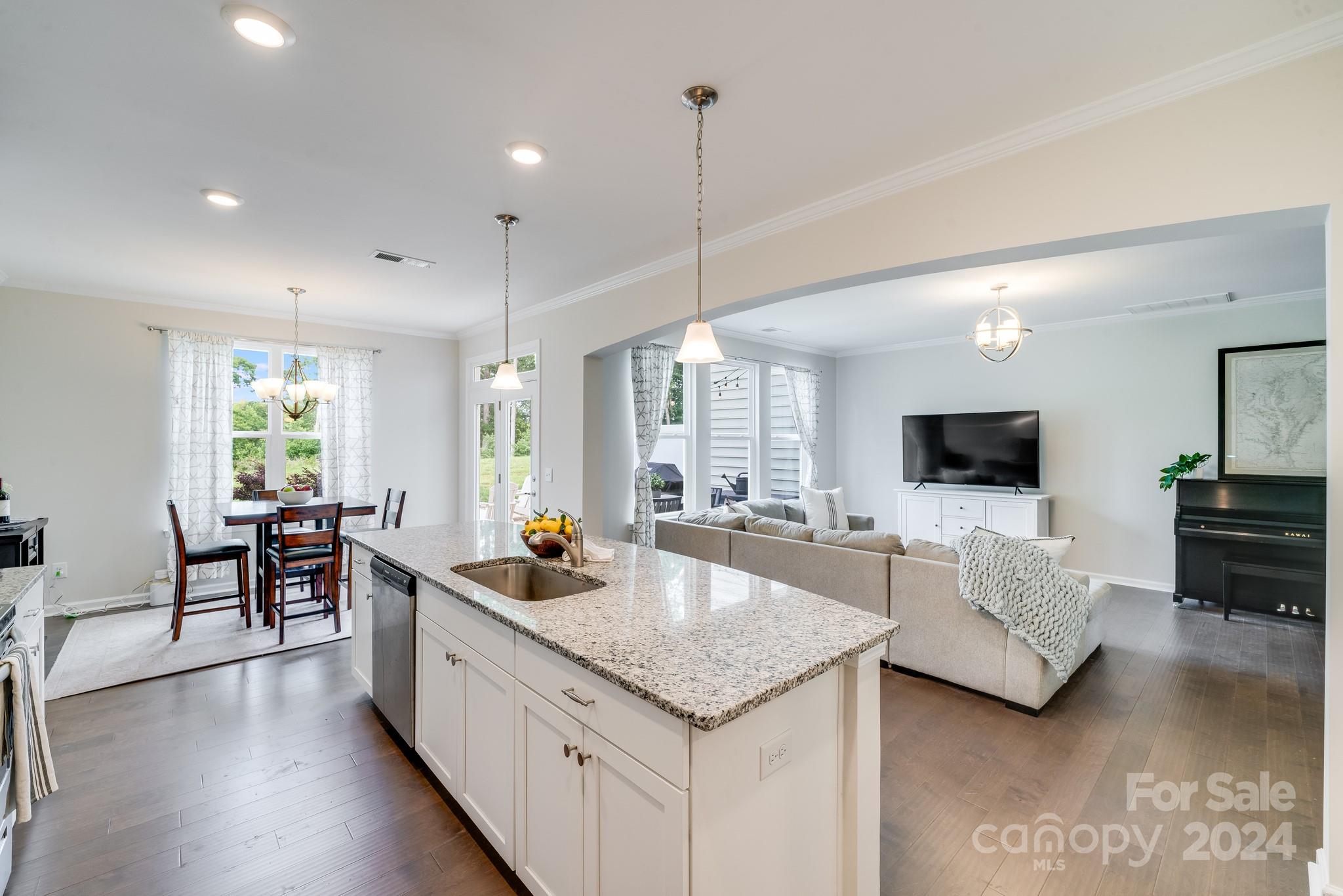 805 River Park Road Belmont, NC 28012 - Photo 8 of 21 a large living room with stainless steel appliances granite countertop couches a flat screen tv and a refrigerator