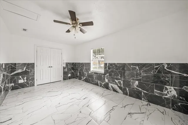 a view of a livingroom with a chair and white walls