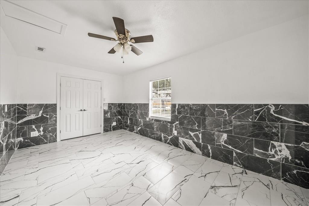 5507 Alexander Street Sachse, TX 75048 - Photo 14 of 18 a view of a livingroom with a chair and white walls
