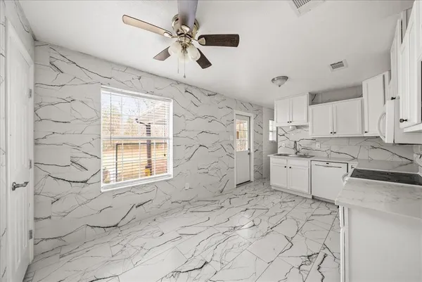 a view of a kitchen with a sink and cabinets