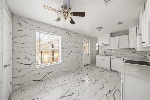 a view of a kitchen with a sink and cabinets