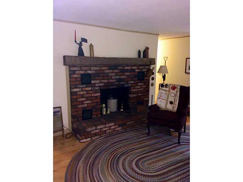 463 Abbott Road Winslow, ME 04901 - Photo 17 of 35 Living Room. Brick fireplace in the...