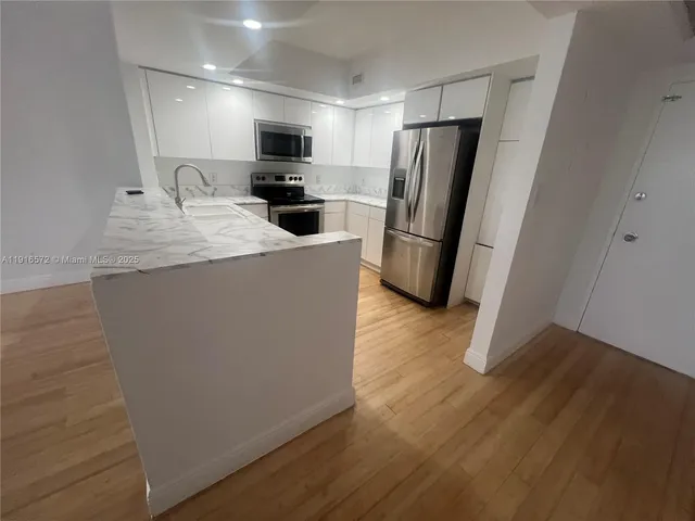a kitchen with a sink stove and microwave