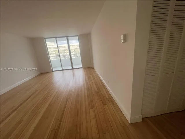 a view of walk in closet with wooden floor and cabinet