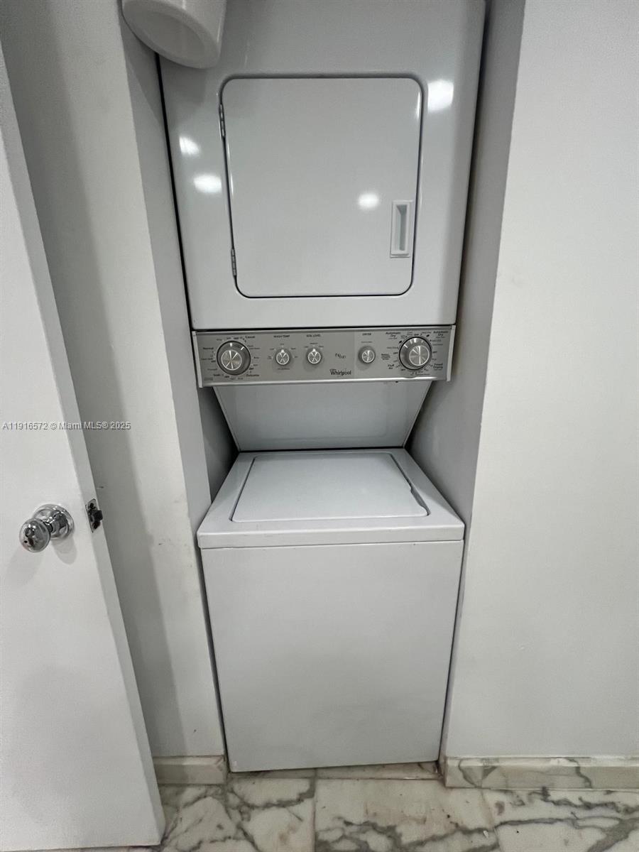 5600 Collins Avenue, Unit 17T Miami Beach, FL 33140 - Photo 31 of 52 a utility room with dryer and washer