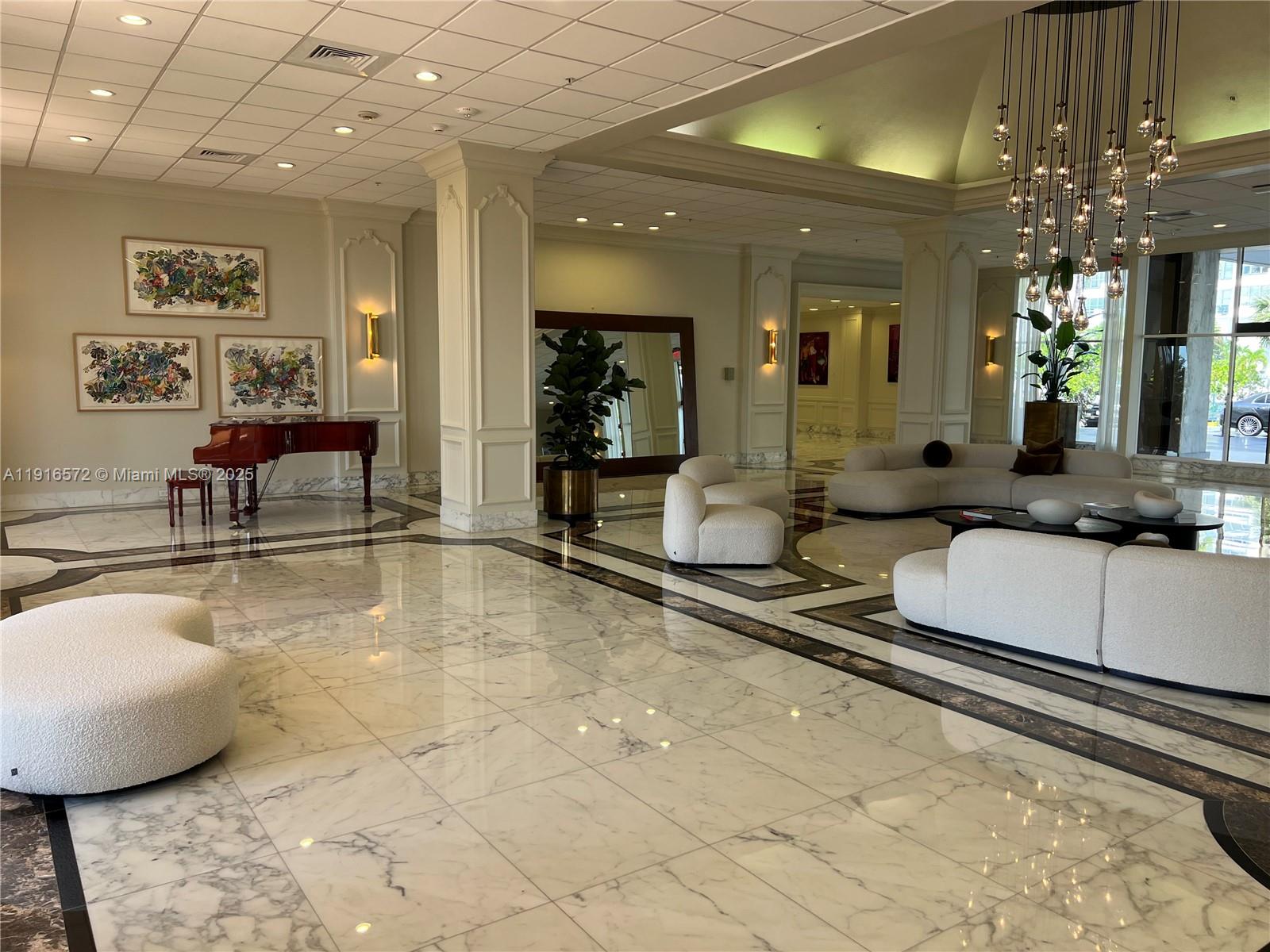 5600 Collins Avenue, Unit 17T Miami Beach, FL 33140 - Photo 42 of 52 a lobby with furniture and a chandelier