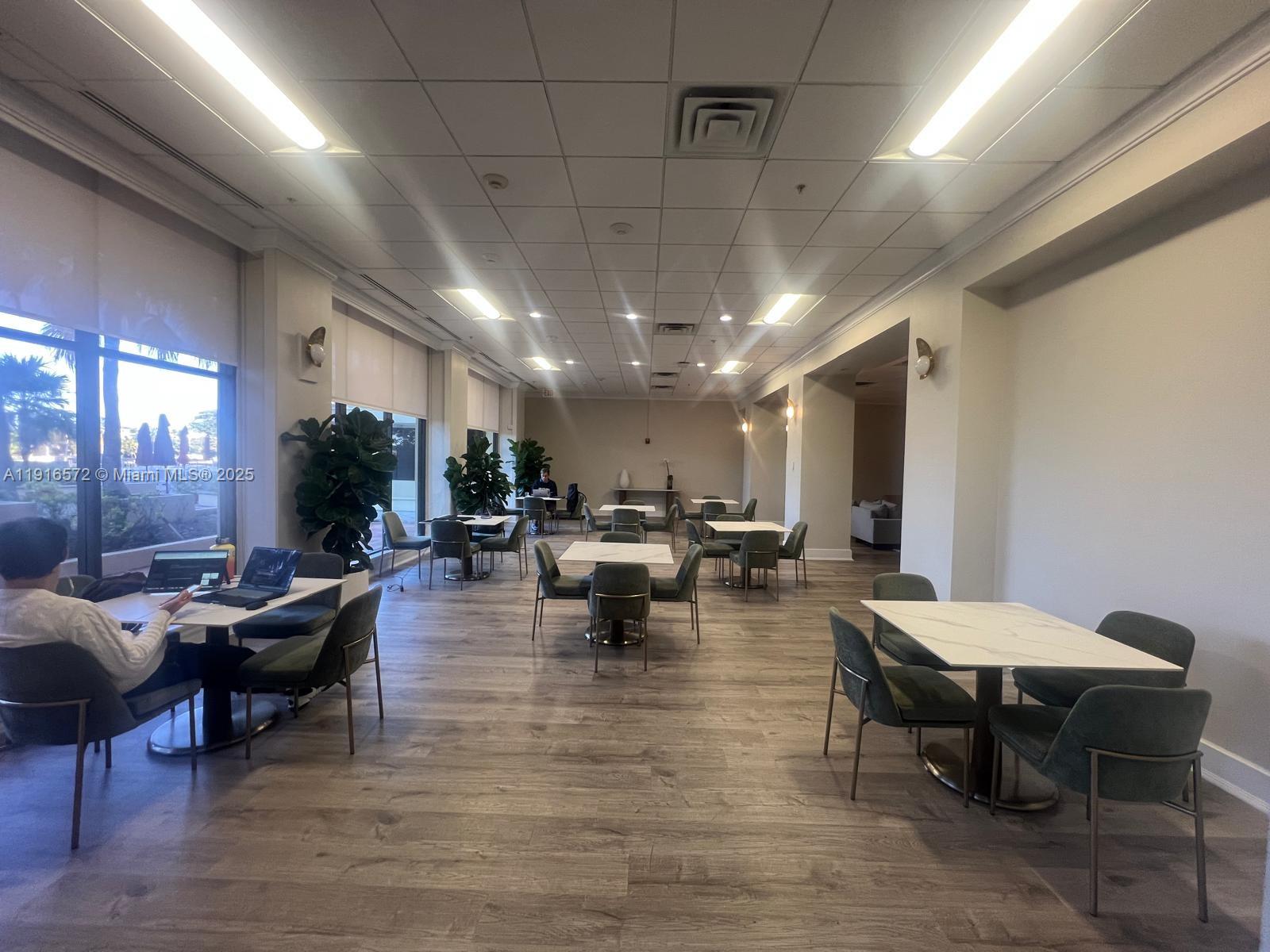 5600 Collins Avenue, Unit 17T Miami Beach, FL 33140 - Photo 44 of 52 a living room with lots of furniture and view of kitchen