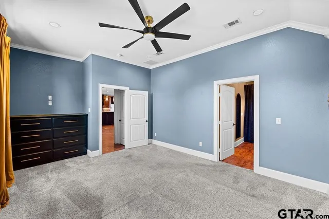 a view of an empty room with closet and cabinet