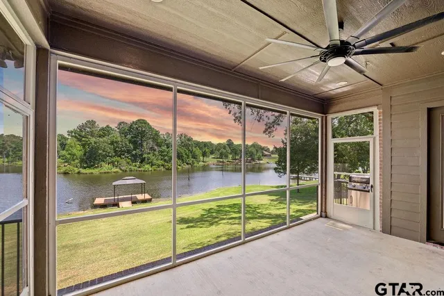 a view of a porch with furniture and garden