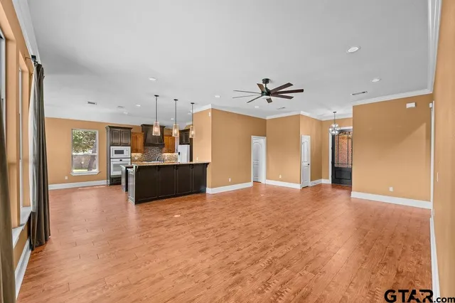 a view of a kitchen with a sink and a refrigerator