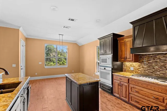 a kitchen with a refrigerator stove and sink