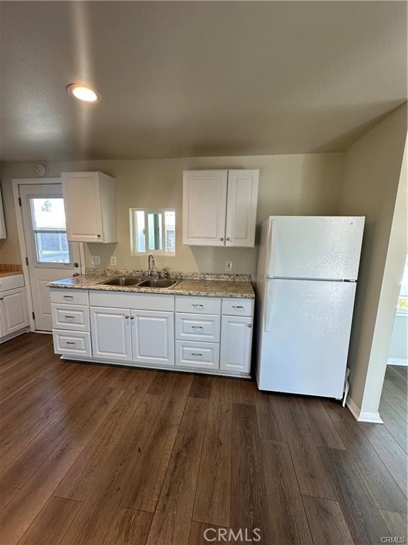 12830 6th Street, Unit 14 Yucaipa, CA 92399 - Photo 11 of 16 a kitchen with stainless steel appliances granite countertop a refrigerator a stove a sink and a granite counter tops with wooden floors