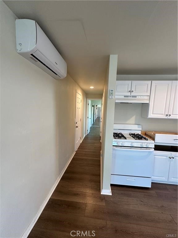 12830 6th Street, Unit 14 Yucaipa, CA 92399 - Photo 12 of 16 a kitchen with kitchen island a stove and a refrigerator