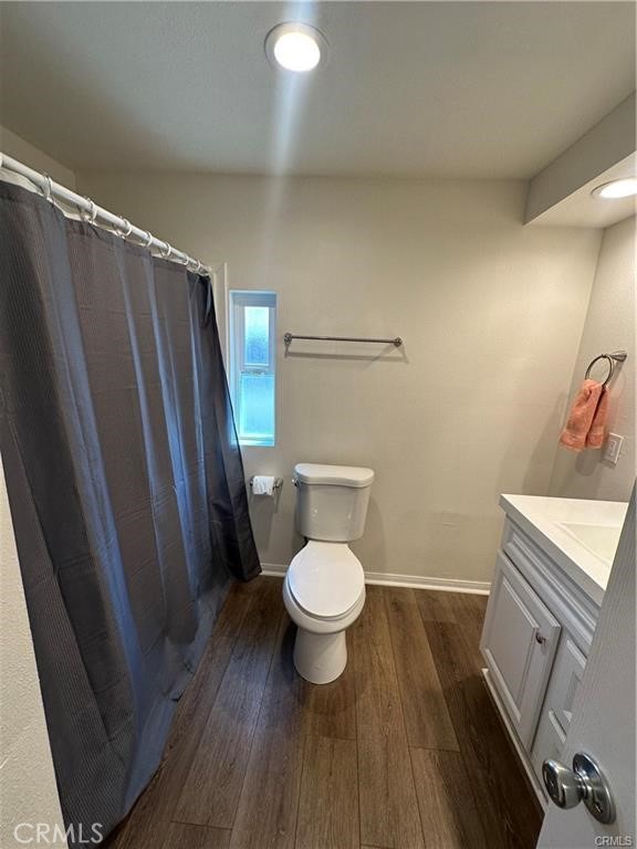 12830 6th Street, Unit 14 Yucaipa, CA 92399 - Photo 13 of 16 a white toilet sitting next to a shower curtain