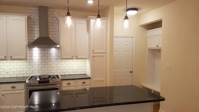 a kitchen with a sink a stove and a window