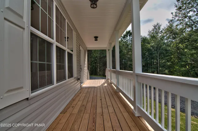 a view of balcony with wooden floor
