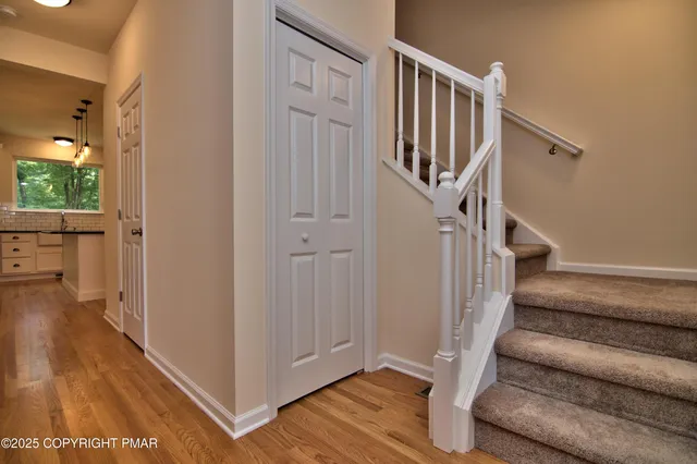 a view of entryway with wooden floor and stairs