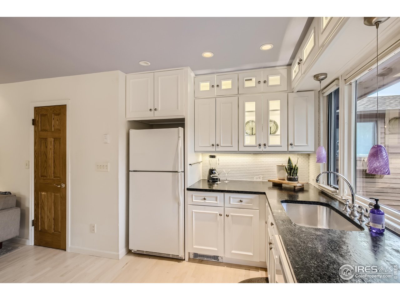 815 Alpine Avenue, Unit 4 Boulder, CO 80304 - Photo 4 of 27 a kitchen with a refrigerator sink and cabinets