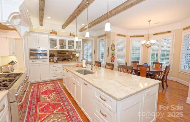 a large white kitchen with a large window