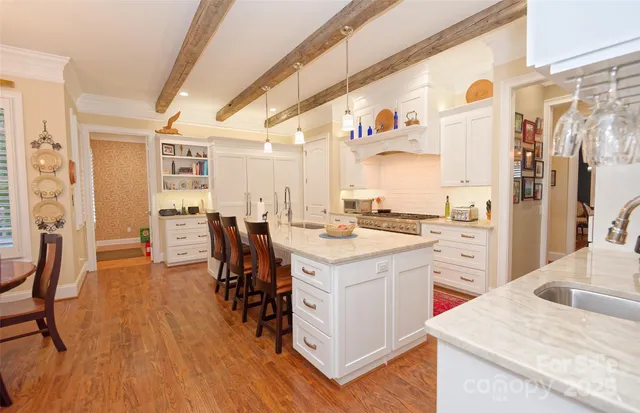 a kitchen with a sink a counter top space and stainless steel appliances