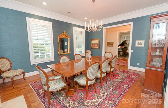 a view of a dining room with furniture and chandelier