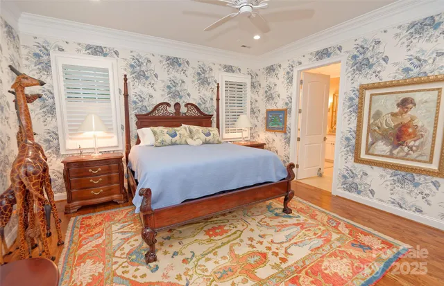 a bedroom with a bed and a painting on the wall