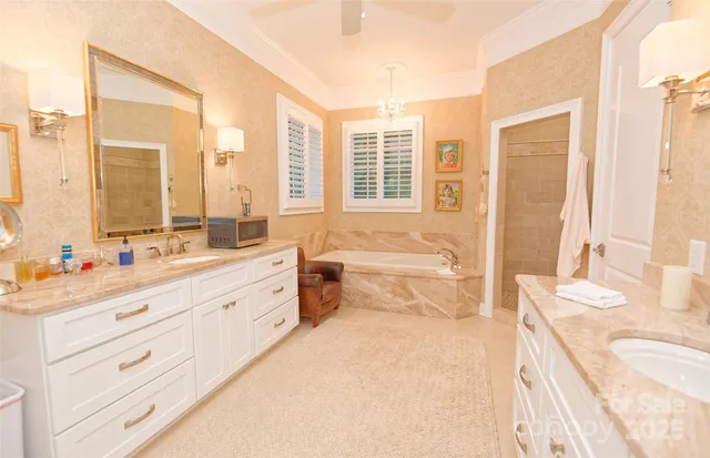 a spacious bathroom with a granite countertop sink mirror and a bathtub