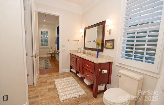 a bathroom with a sink vanity granite and toilet