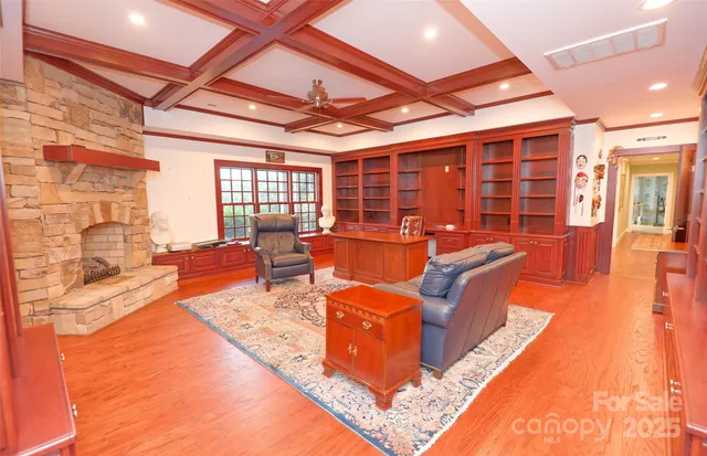 a living room with furniture a fireplace and wooden floor