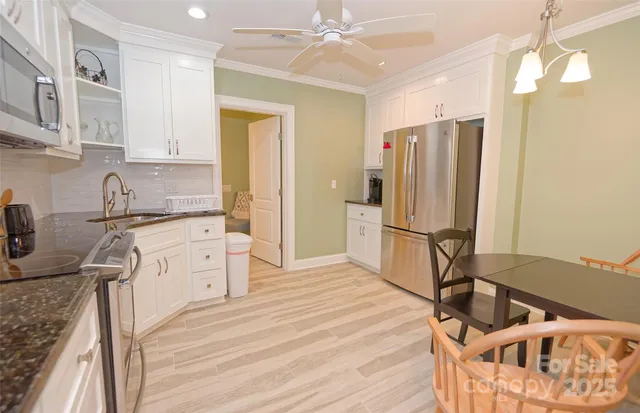 a kitchen with stainless steel appliances a stove a refrigerator and cabinets