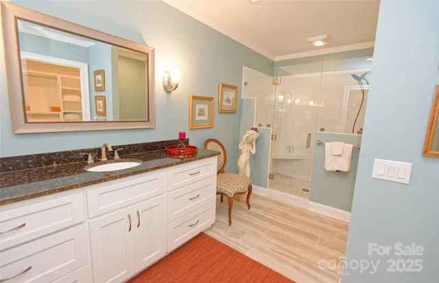a spacious bathroom with a double vanity sink a mirror and a shower