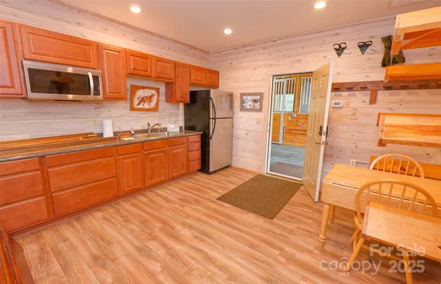 a kitchen with stainless steel appliances granite countertop a sink and cabinets