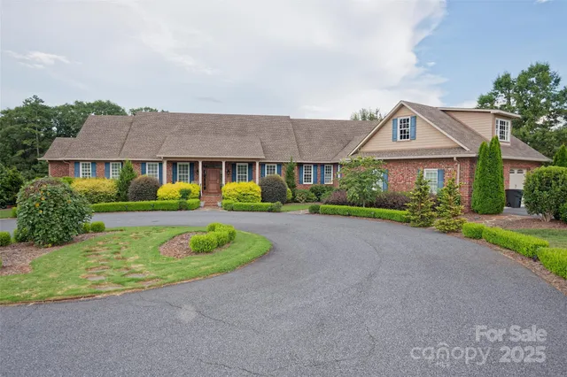 a front view of a house with a garden and plants