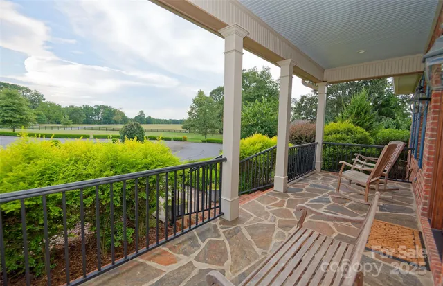 a view of a balcony with lake view and wooden floor