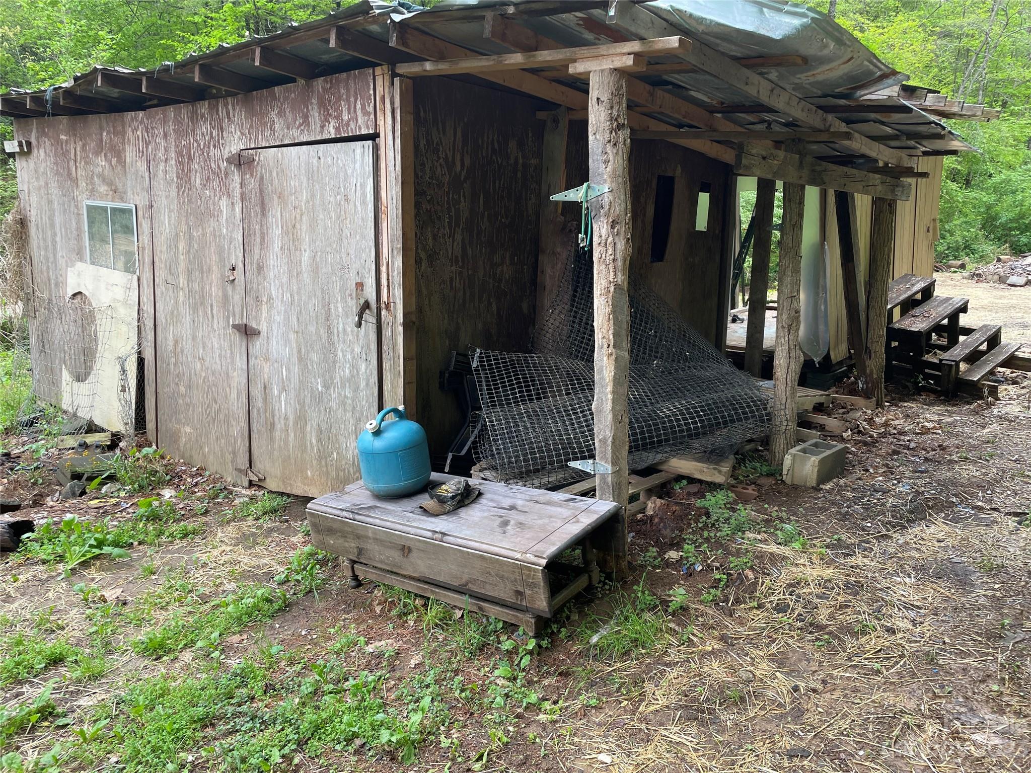 96 Sabbath Drive Old Fort, NC 28762 - Photo 3 of 25 a backyard of a house with barbeque oven table and chairs