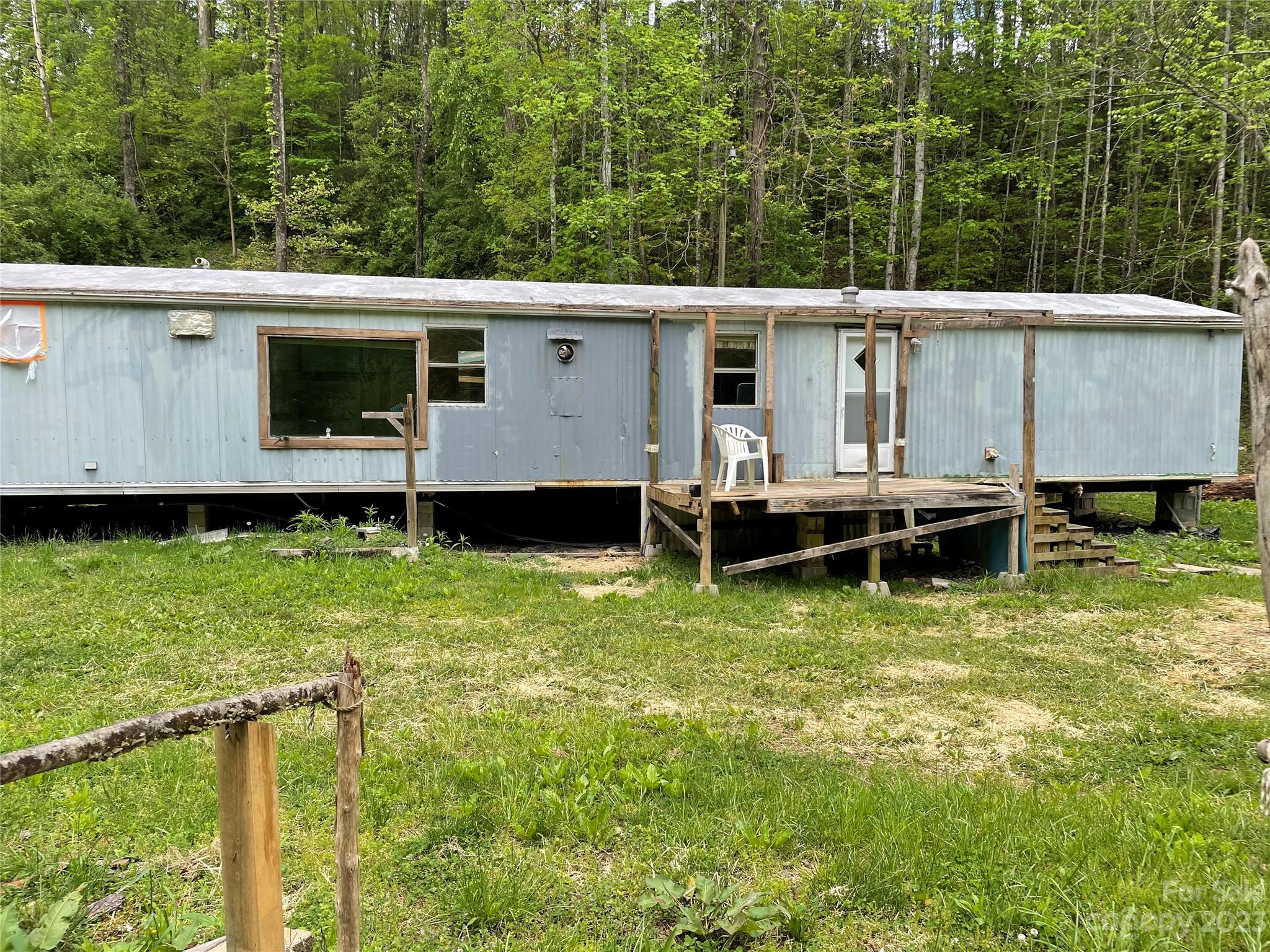 96 Sabbath Drive Old Fort, NC 28762 - Photo 8 of 25 a view of a house with backyard and sitting area