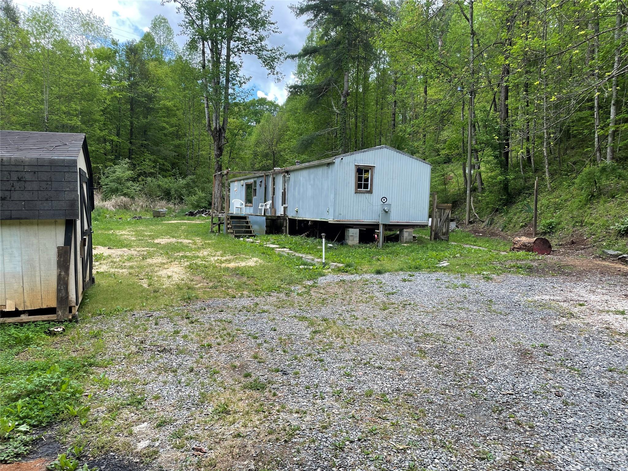 96 Sabbath Drive Old Fort, NC 28762 - Photo 9 of 25 a view of a barn in the middle of a yard