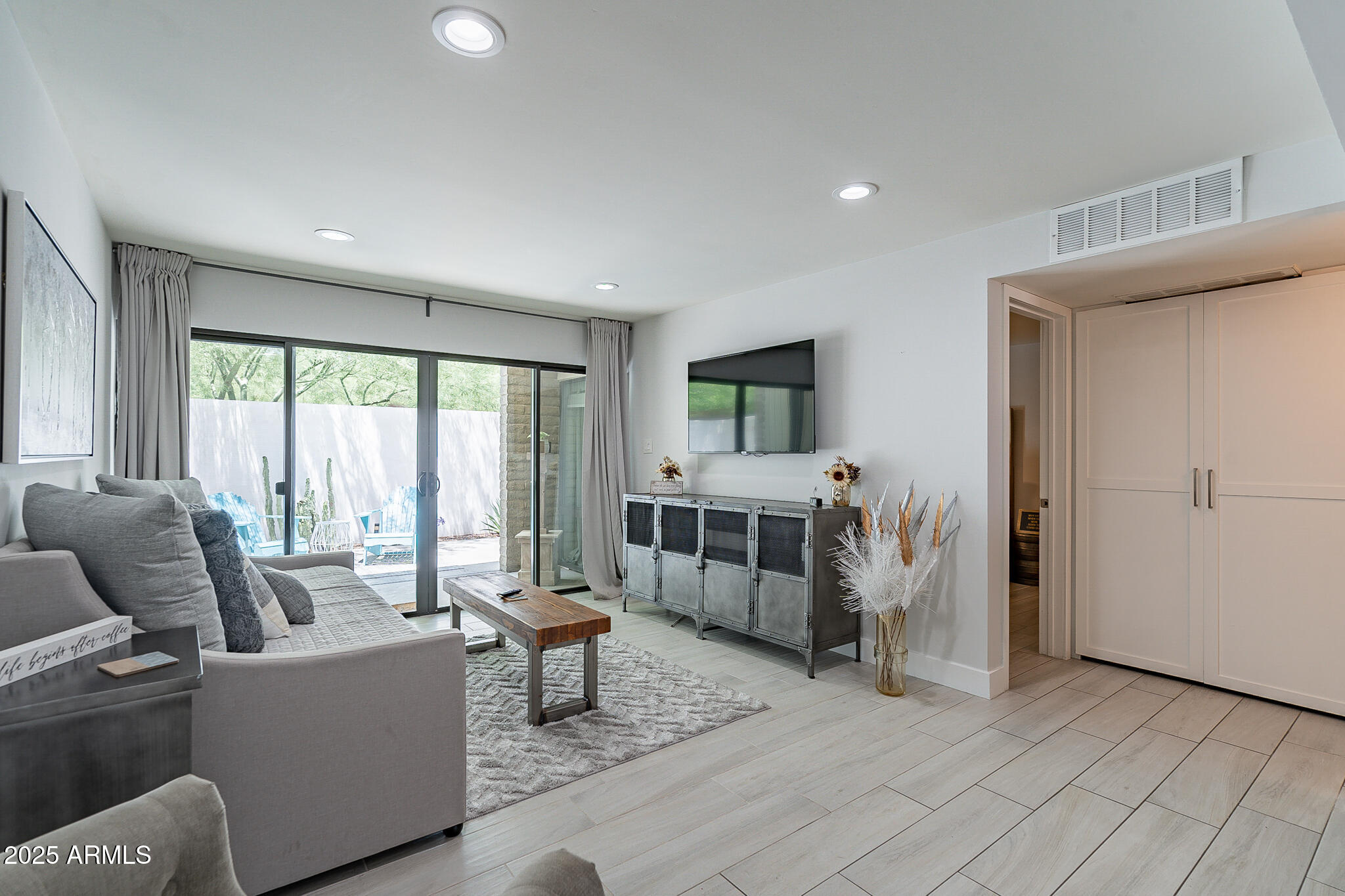 4351 North 36th Street, Unit 2 Phoenix, AZ 85018 - Photo 16 of 24 a living room with furniture and large windows