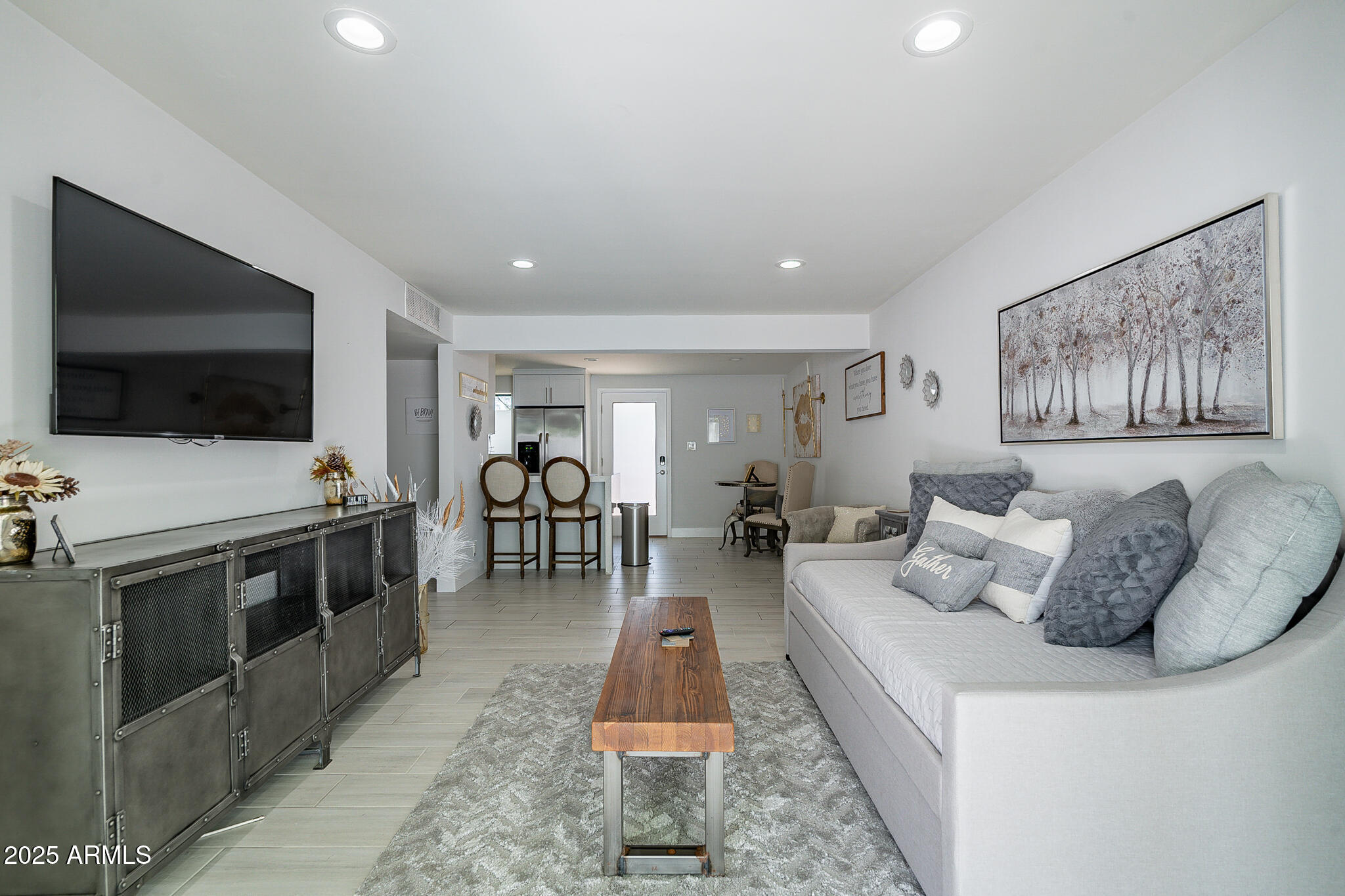 4351 North 36th Street, Unit 2 Phoenix, AZ 85018 - Photo 19 of 24 a living room with furniture and a flat screen tv
